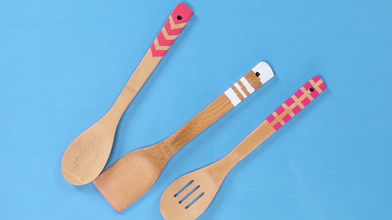 Painted wood kitchen utensils displayed on a table