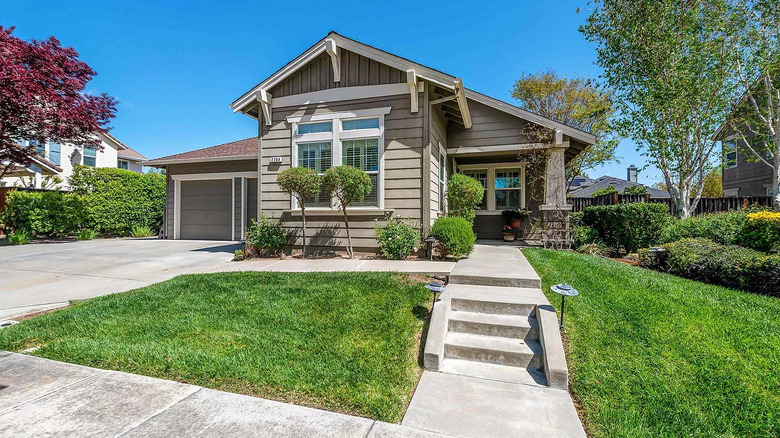 ranch home with green siding