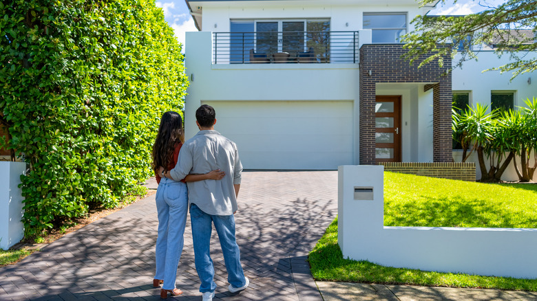 couple in front of house