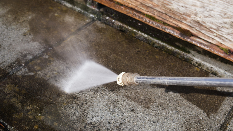 pressure washer cleaning pavement