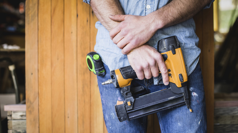 Man holding nail gun