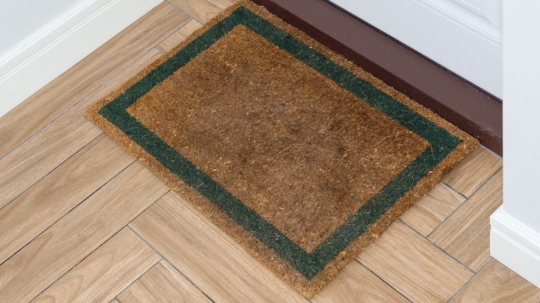 Coir doormat with green border