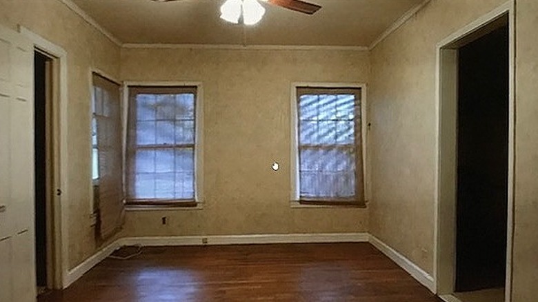 Small empty beige bedroom