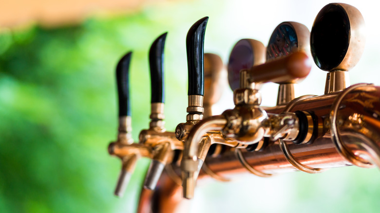 An outdoor copper beer tap