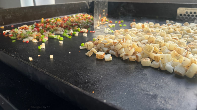 Food being cooked on a flat top griddle