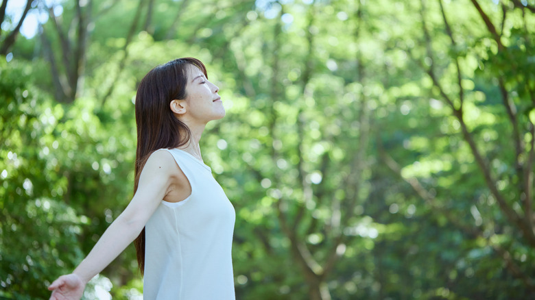 Woman breathing deeply in forest