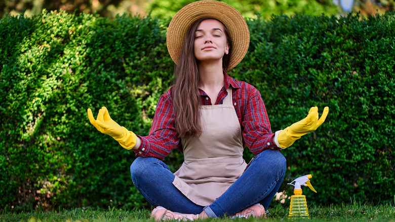 Gardener meditating in the grass