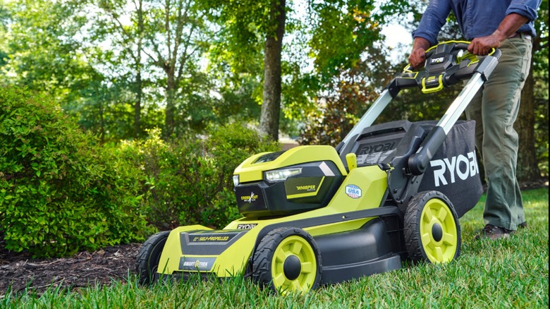 A man pushing a 40V Ryobi lawn mower