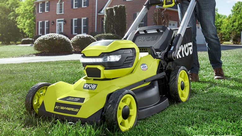 A man pushing a 40V Ryobi lawn mower