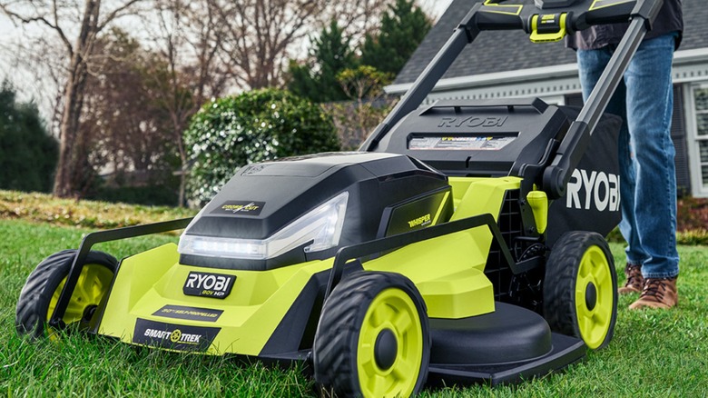 a man pushing an 80V Ryobi lawn mower