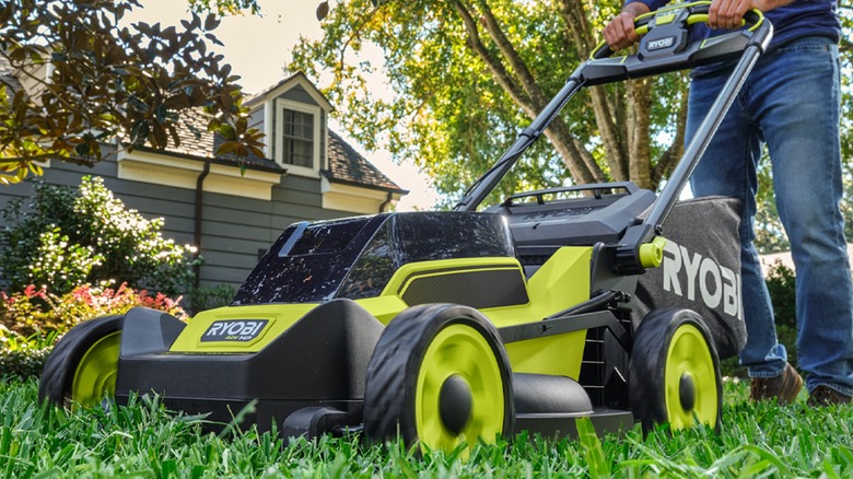 A person pushing a Ryobi 40V mower