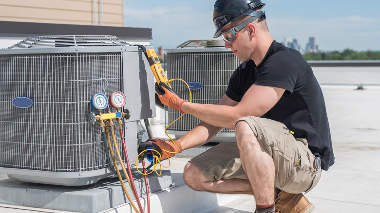 person checking an air conditioner