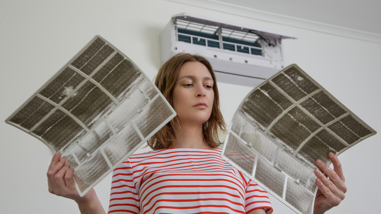 person with air conditioner filters