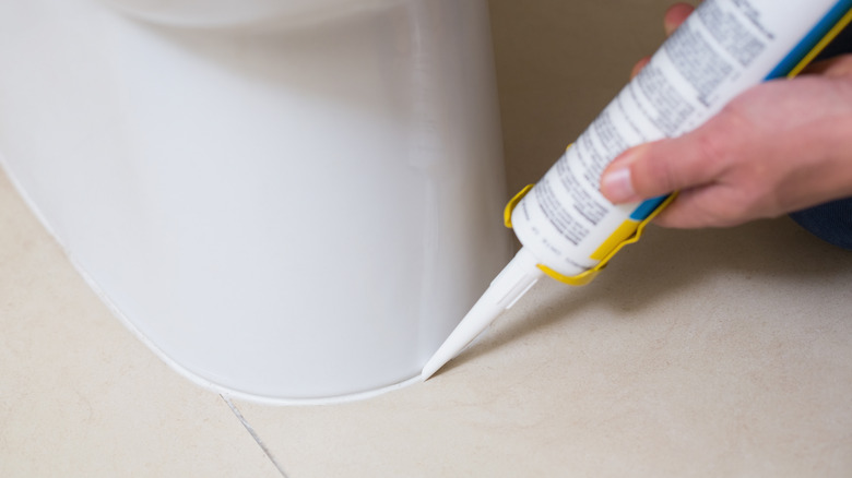 plumber fixing toilet with cartridge