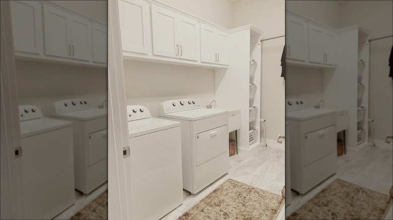 white laundry room with cabinets