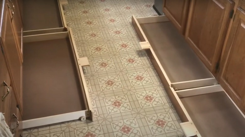 Open toe kick drawers in a kitchen