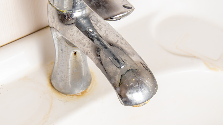 A faucet with hard water stains