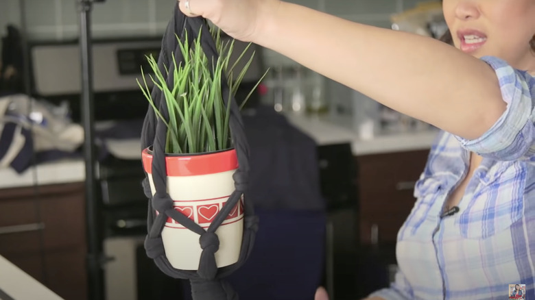 woman holding diy tshirt plant holder