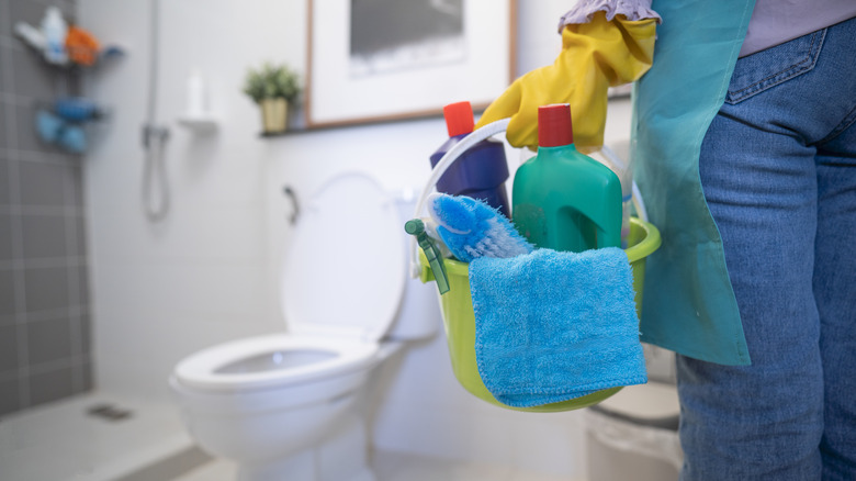 Woman with cleaning supply bucket