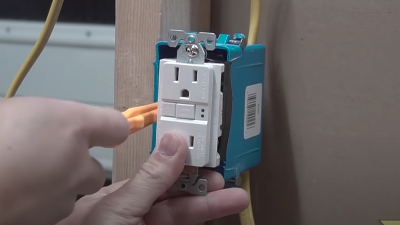 Person installing GFCI plug