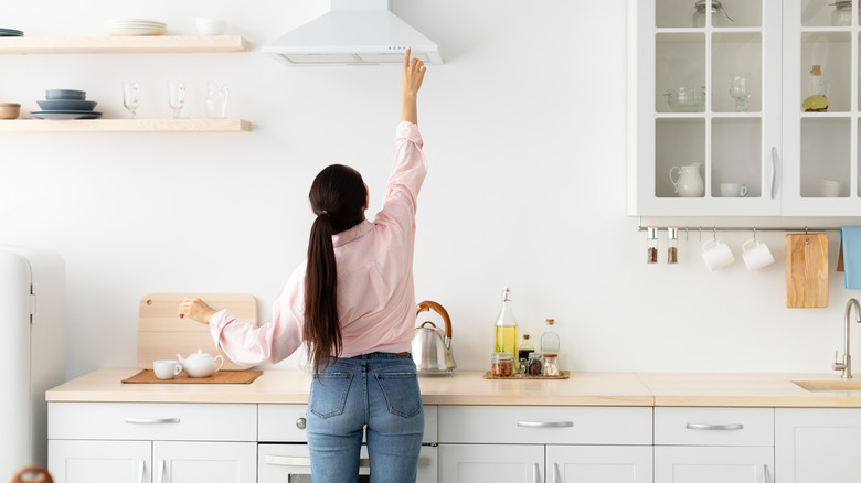 Person using kitchen range vent