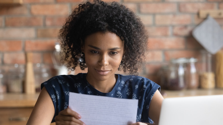 woman looking over a reference report