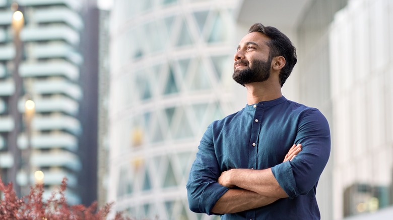 man contemplating real estate