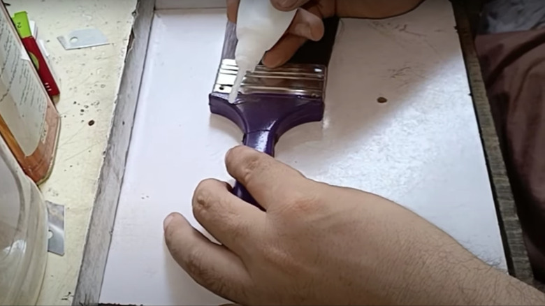 Gluing handle of broken paintbrush