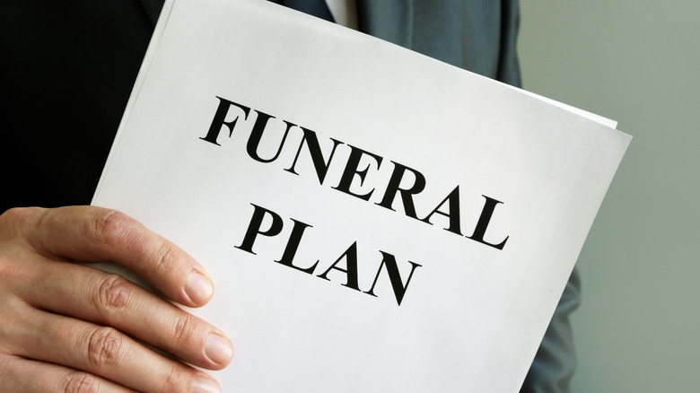 man holding funeral plan