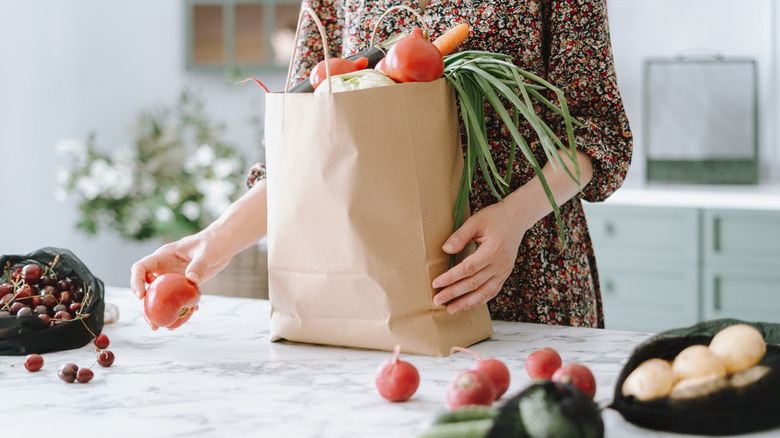 unpacking groceries from paper bag