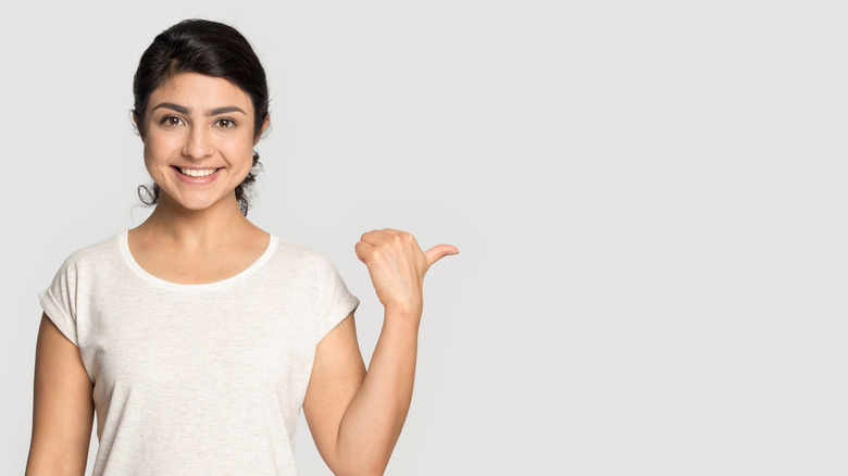 Person pointing at a wall