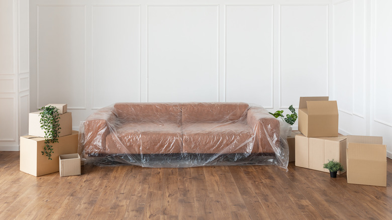 Covered couch with boxes