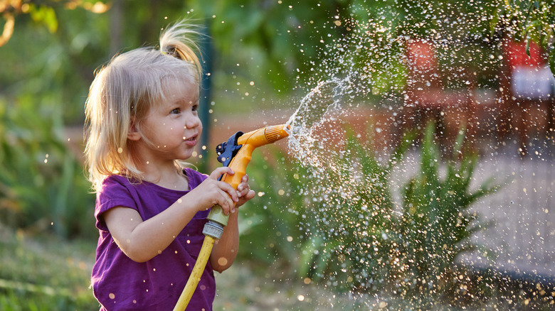 Child with garden hose
