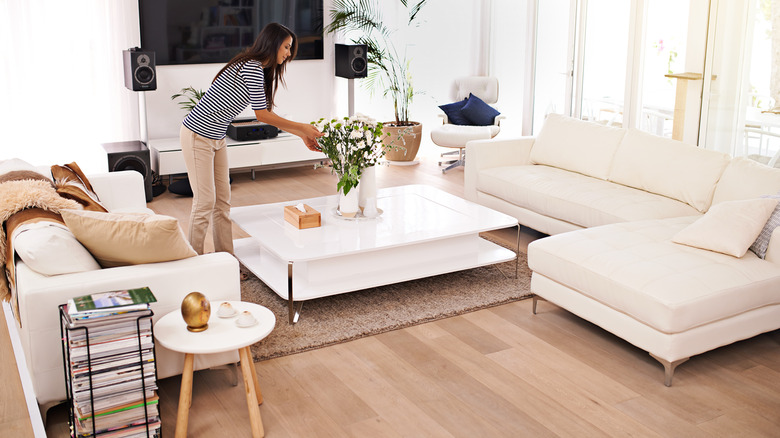 Woman tidying living room