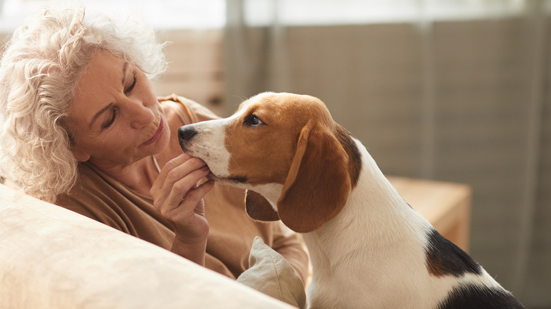 woman giving medicine to dog