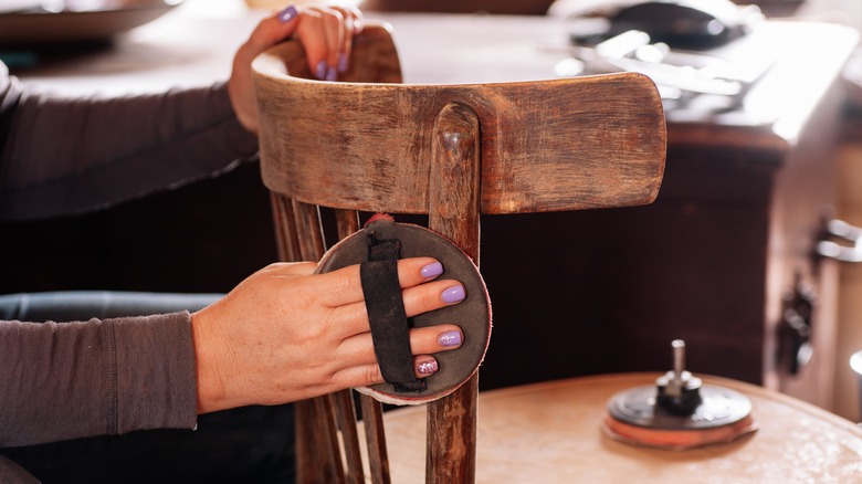 Hands sanding furniture