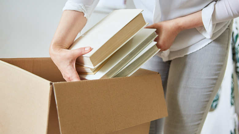 Person placing books in box