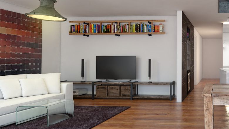 bookshelf near ceilingabove television