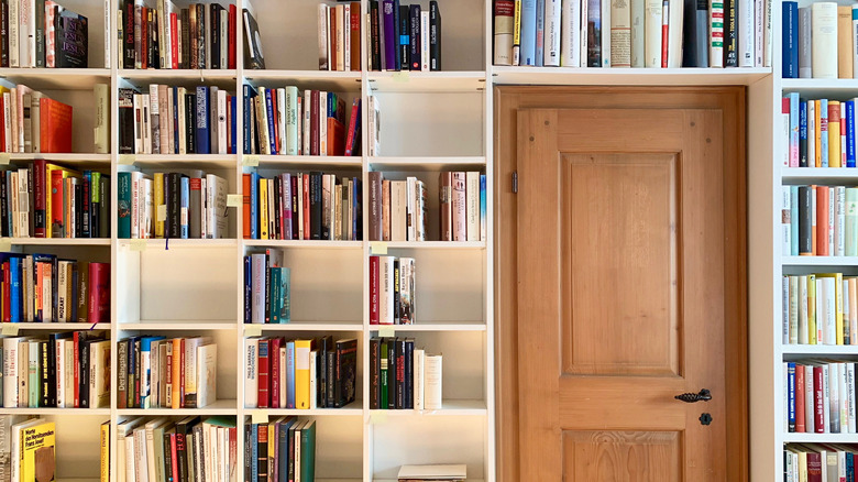 bookshelves around wooden door