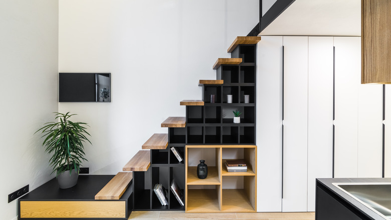 black shelves underneath staircase