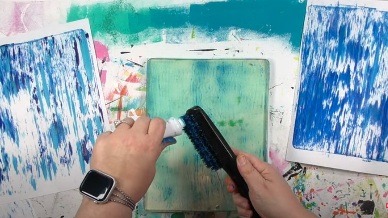 squeezing paint onto hair brush