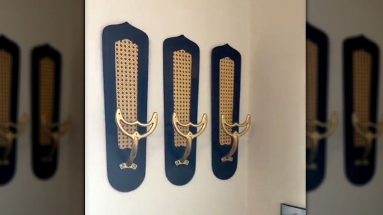 Three ceiling fan blades converted into hooks on the wall