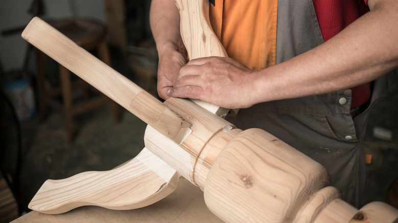 carpenter builds table legs