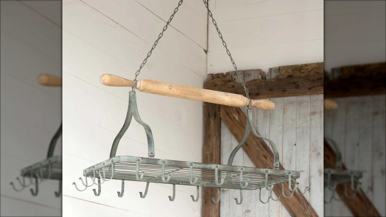 Hanging metal pot rack with rolling pin attached as the base