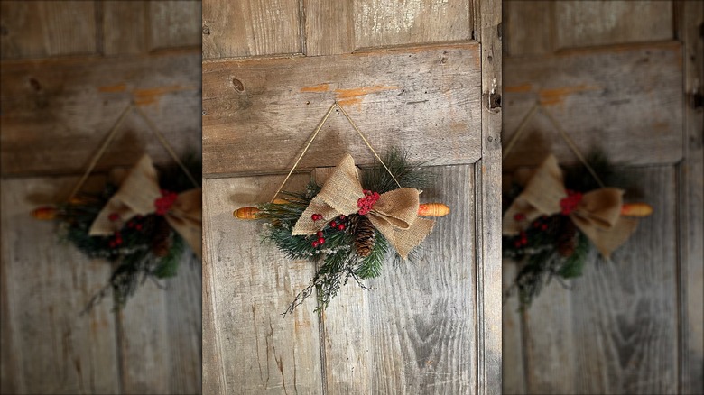 Rolling pin Christmas wreath hung on a wooden door