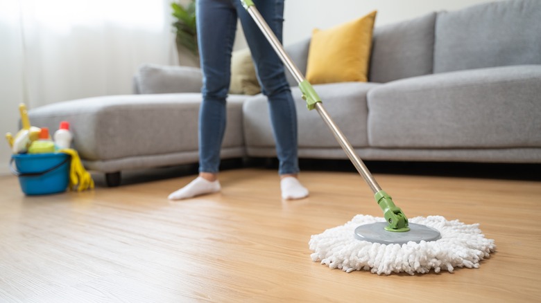 A woman mopping the floor