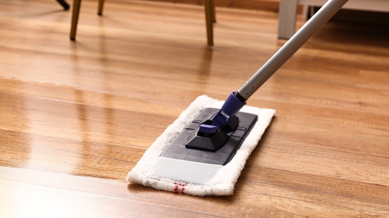 A person mopping their laminate floor