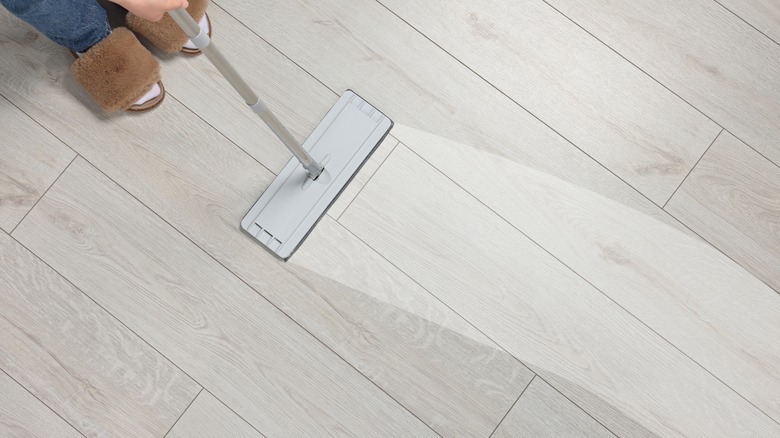 A person mopping laminate floor