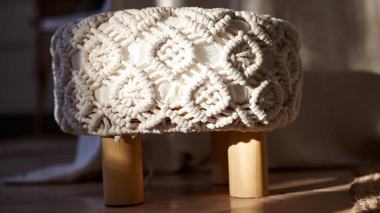 footstool covered in macrame