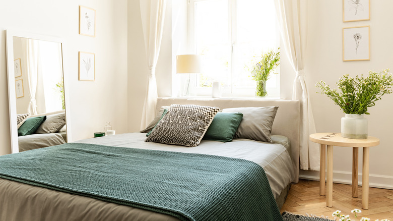 styled bedroom with a large window 